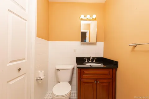 a bathroom with a toilet a sink and mirror