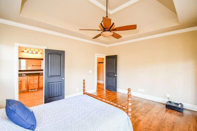 4814 Amal Lane Gainesville, GA 30506 - Photo 11 of 40 a bedroom with a bed and dresser with wooden floor