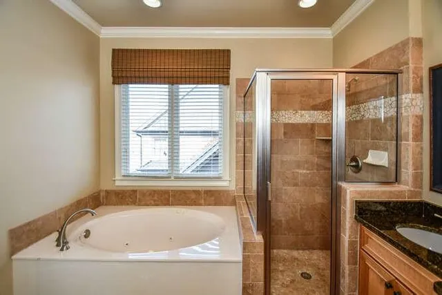 a bathroom with a bathtub and shower