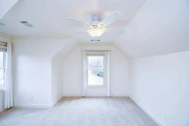 a view of a chandelier fan and a window