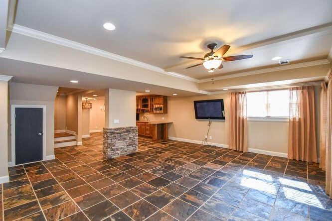 4814 Amal Lane Gainesville, GA 30506 - Photo 24 of 40 a living room with a gaming space and a chandelier