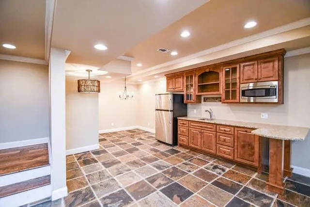 a kitchen with stainless steel appliances granite countertop a refrigerator and a sink