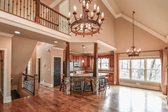4814 Amal Lane Gainesville, GA 30506 - Photo 4 of 40 an open kitchen with wooden floor and chandelier