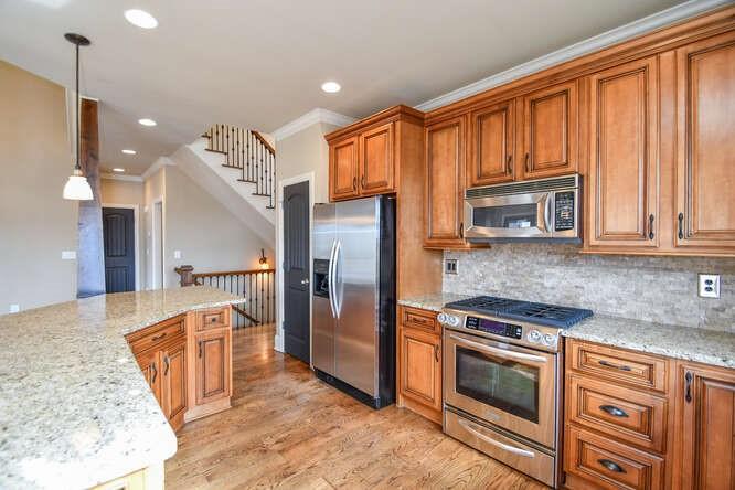 4814 Amal Lane Gainesville, GA 30506 - Photo 7 of 40 a kitchen with stainless steel appliances granite countertop a refrigerator a stove and a sink with cabinets