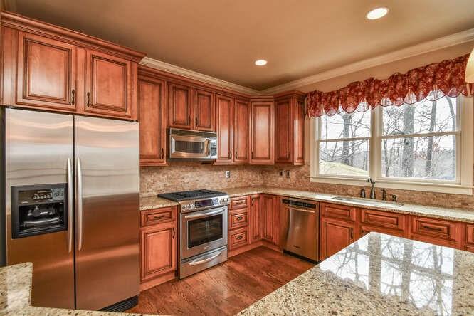4814 Amal Lane Gainesville, GA 30506 - Photo 9 of 40 a kitchen with stainless steel appliances granite countertop a refrigerator and a sink
