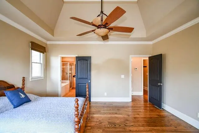 a bedroom with a bed and a chandelier