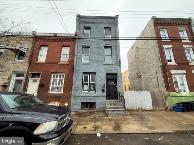 a view of a brick house with many windows