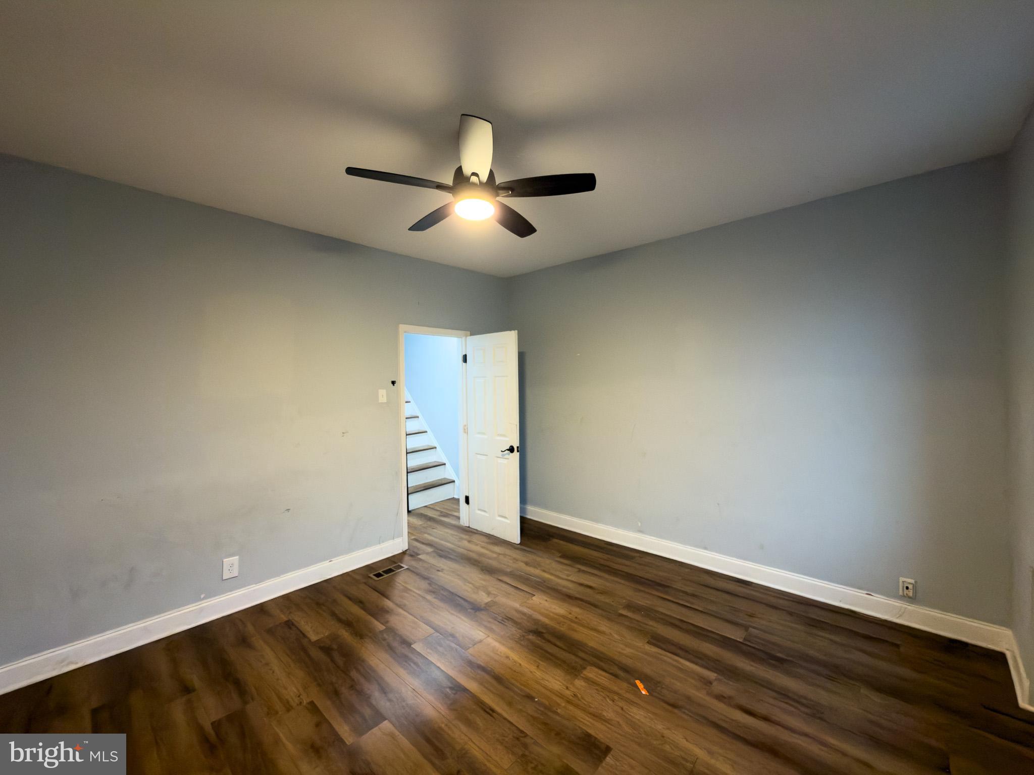 1848 North 27th Street Philadelphia, PA 19121 - Photo 15 of 29 an empty room with wooden floor and ceiling fan