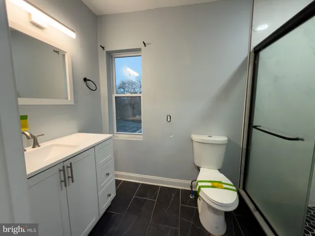 a bathroom with a sink toilet and mirror