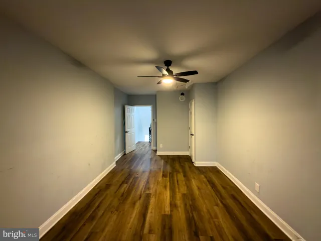 wooden floor in an empty room with a chandelier