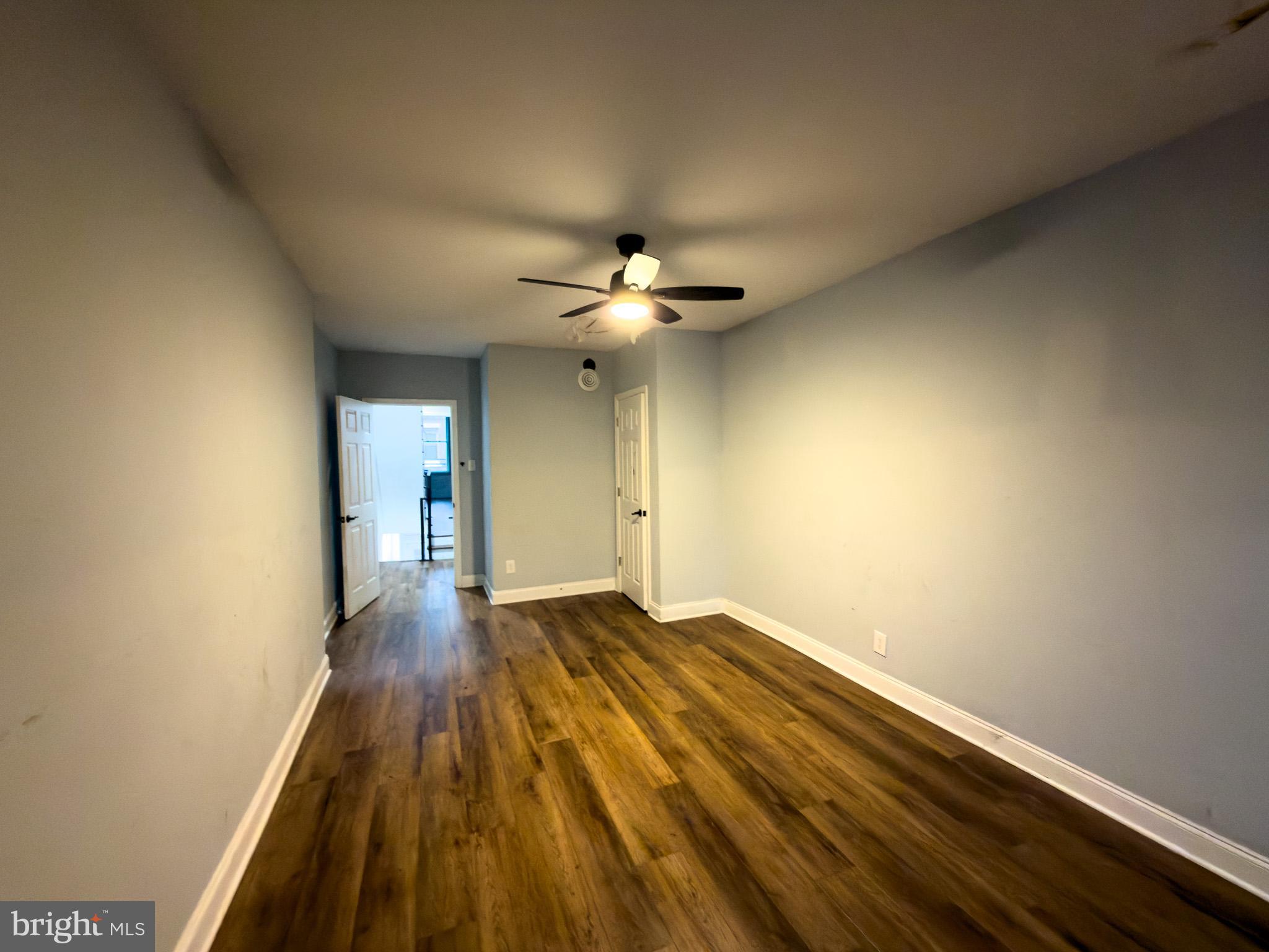 1848 North 27th Street Philadelphia, PA 19121 - Photo 22 of 29 wooden floor in an empty room with a chandelier