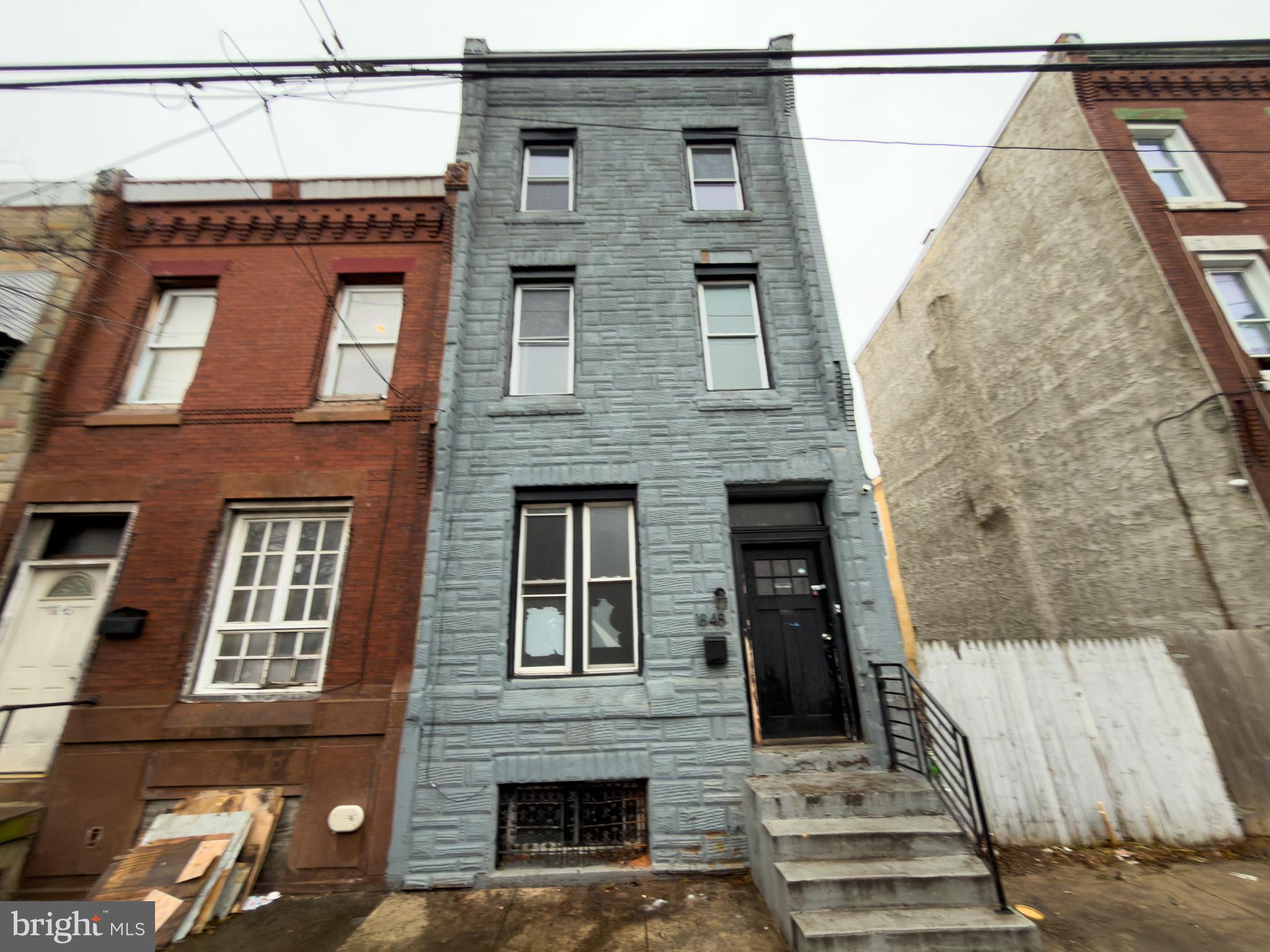1848 North 27th Street Philadelphia, PA 19121 - Photo 26 of 29 a front view of a house with large windows