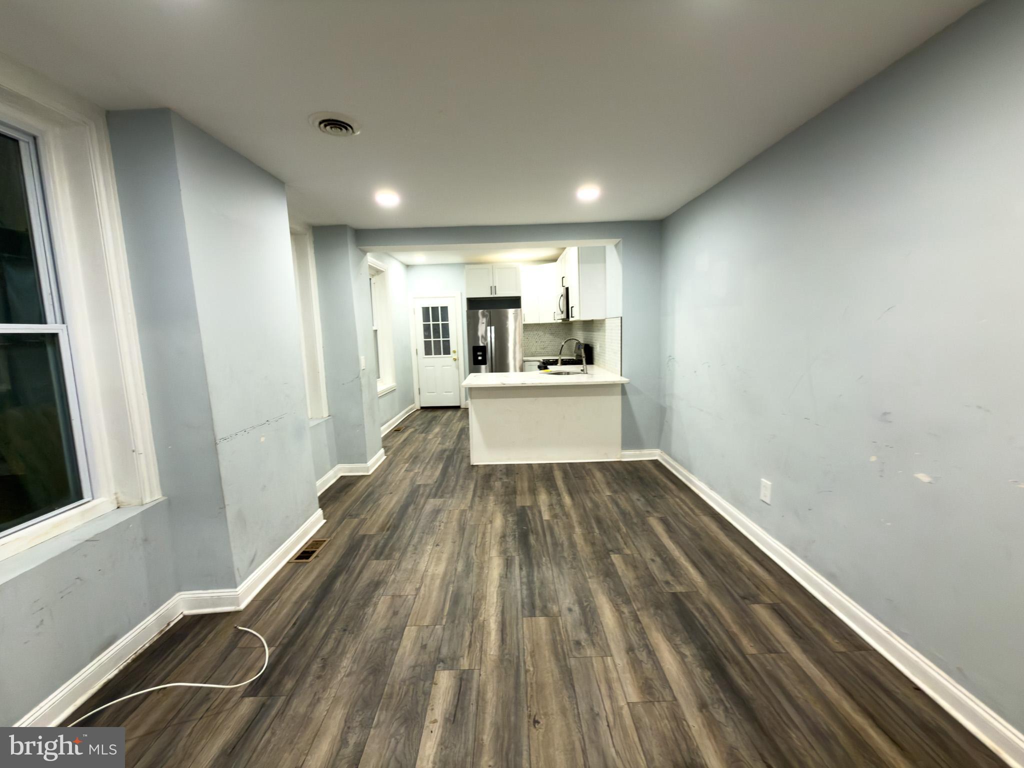 1848 North 27th Street Philadelphia, PA 19121 - Photo 5 of 29 a view of a kitchen with wooden floor and electronic appliances