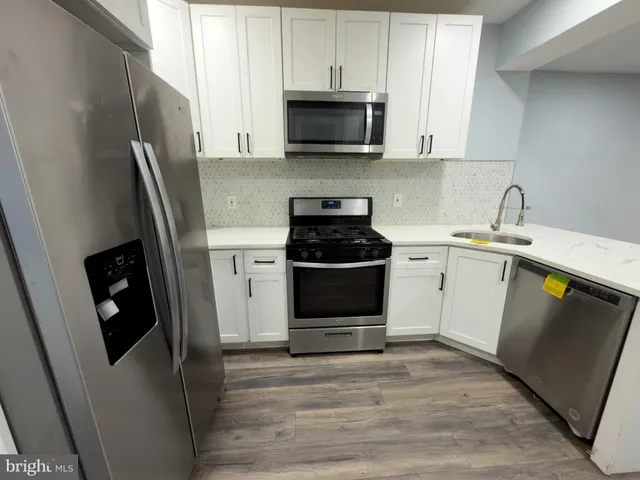 a kitchen with a sink stove and microwave