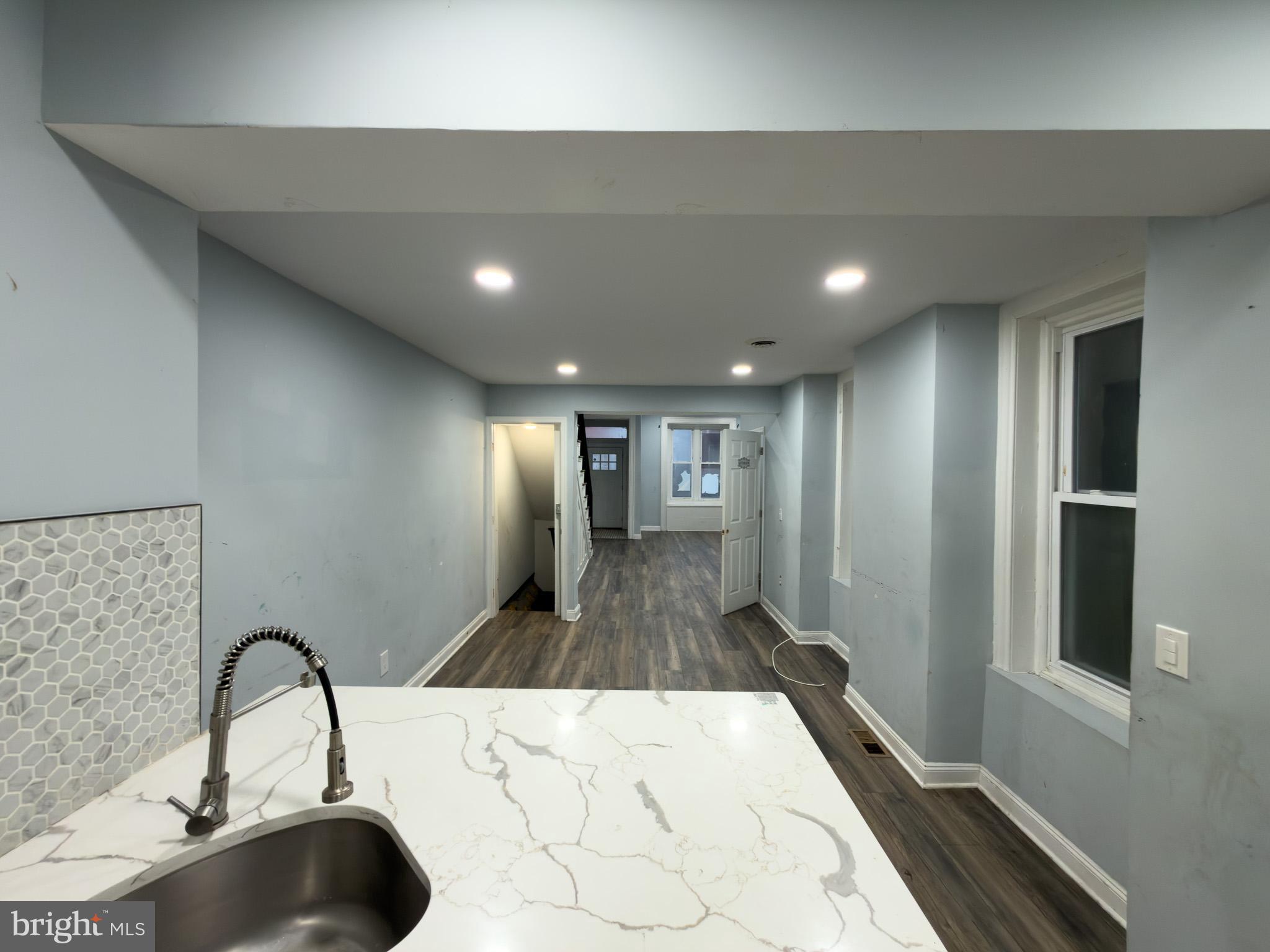 1848 North 27th Street Philadelphia, PA 19121 - Photo 9 of 29 a hall with a sink and a large mirror