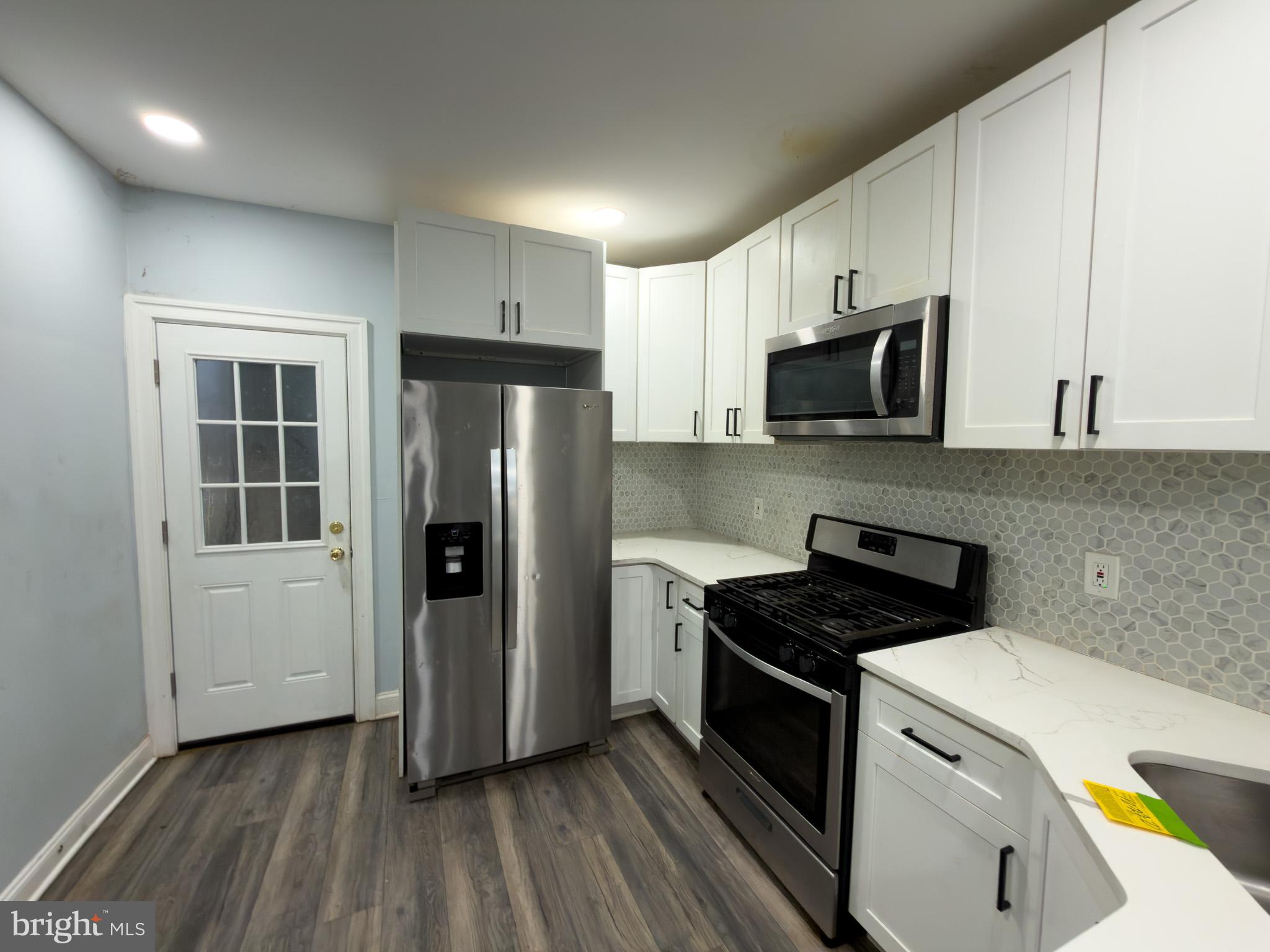 1848 North 27th Street Philadelphia, PA 19121 - Photo 10 of 29 a kitchen with a refrigerator and a stove top oven