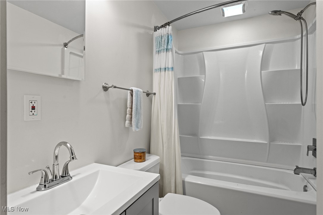 152 Harper Road Streetsboro, OH 44241 - Photo 16 of 34 Bathroom featuring shower / bath combination with curtain and vanity