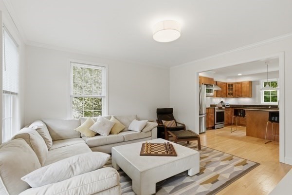 3 Wing Road Wilmington, MA 01887 - Photo 13 of 36 a living room with furniture and a wooden floor