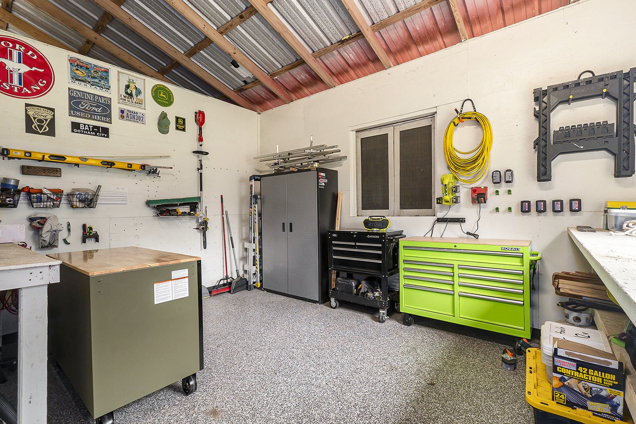 7363 County Line Road Willis, TX 77378 - Photo 31 of 34 Ideal for DIY enthusiasts, this well-organized workshop in the barn offers ample space and storage for your projects.