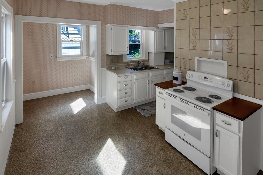 20 Usher Road Medford, MA 02155 - Photo 12 of 42 a kitchen that has a stove and a granite counter tops