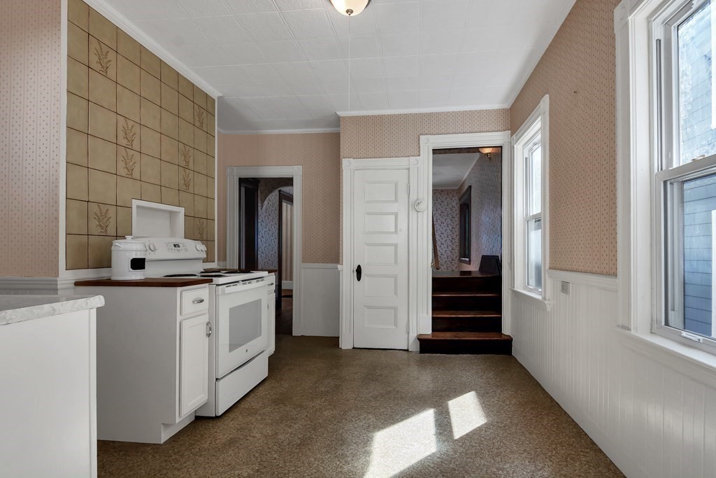 20 Usher Road Medford, MA 02155 - Photo 13 of 42 a large white kitchen with granite countertop a sink and dishwasher a stove with cabinets