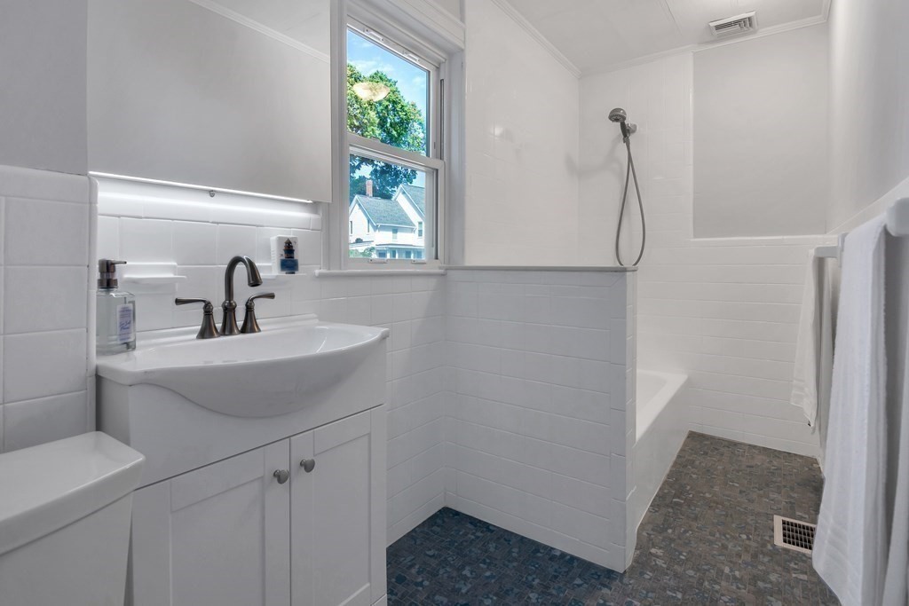 20 Usher Road Medford, MA 02155 - Photo 15 of 42 a bathroom with a sink and a mirror