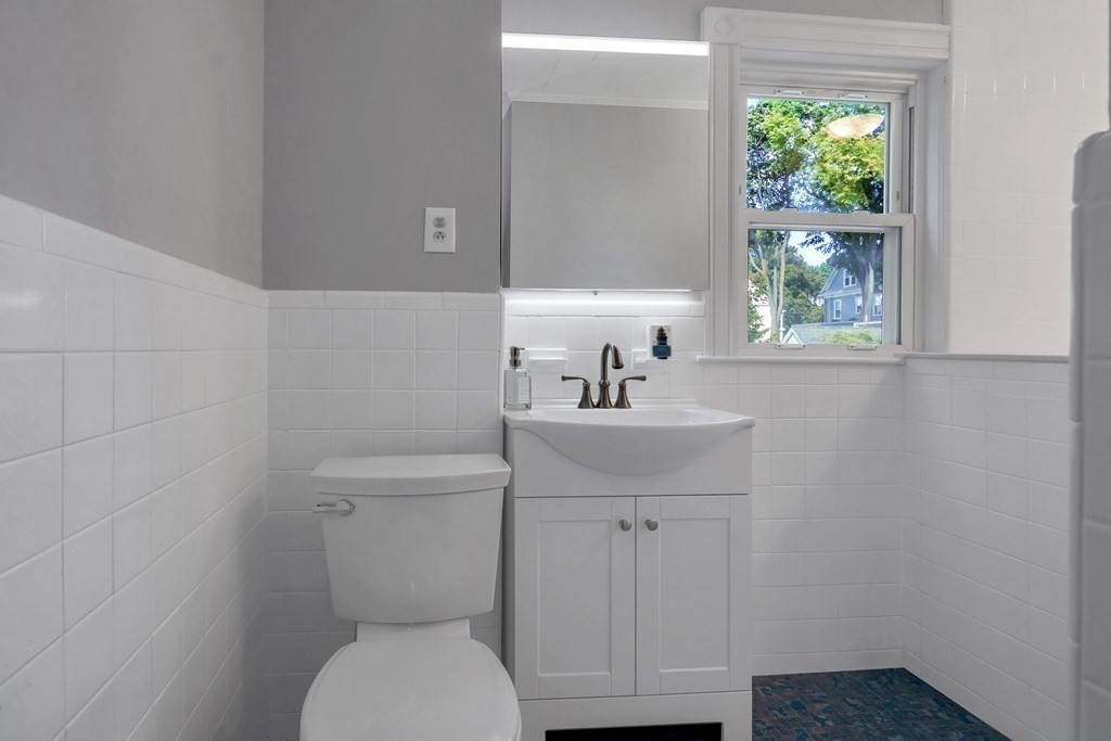 20 Usher Road Medford, MA 02155 - Photo 16 of 42 a bathroom with a toilet a sink and a window