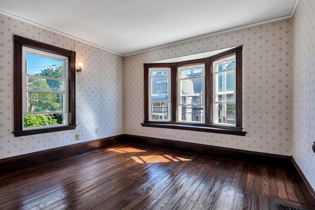 20 Usher Road Medford, MA 02155 - Photo 19 of 42 a view of an empty room with wooden floor and a window