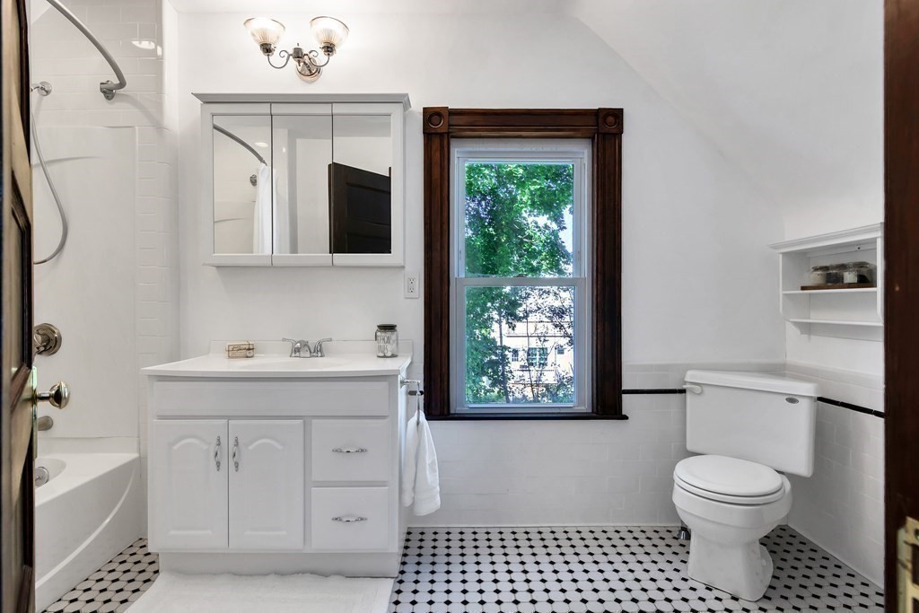 20 Usher Road Medford, MA 02155 - Photo 26 of 42 a bathroom with a toilet a sink a vanity and mirror