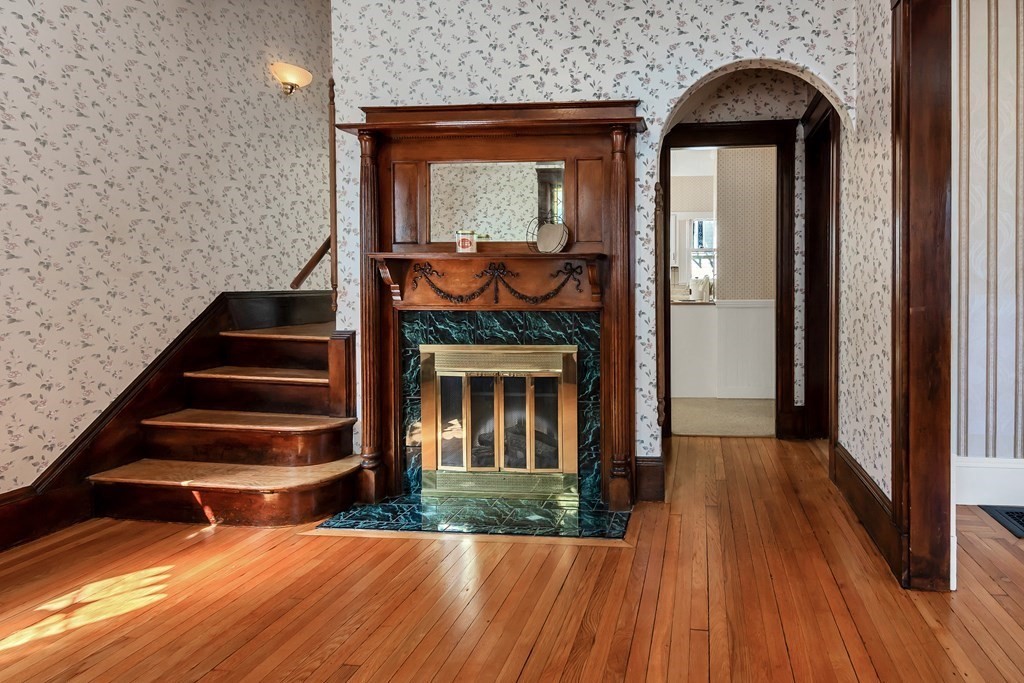20 Usher Road Medford, MA 02155 - Photo 3 of 42 a view of entryway with wooden floor and a fireplace