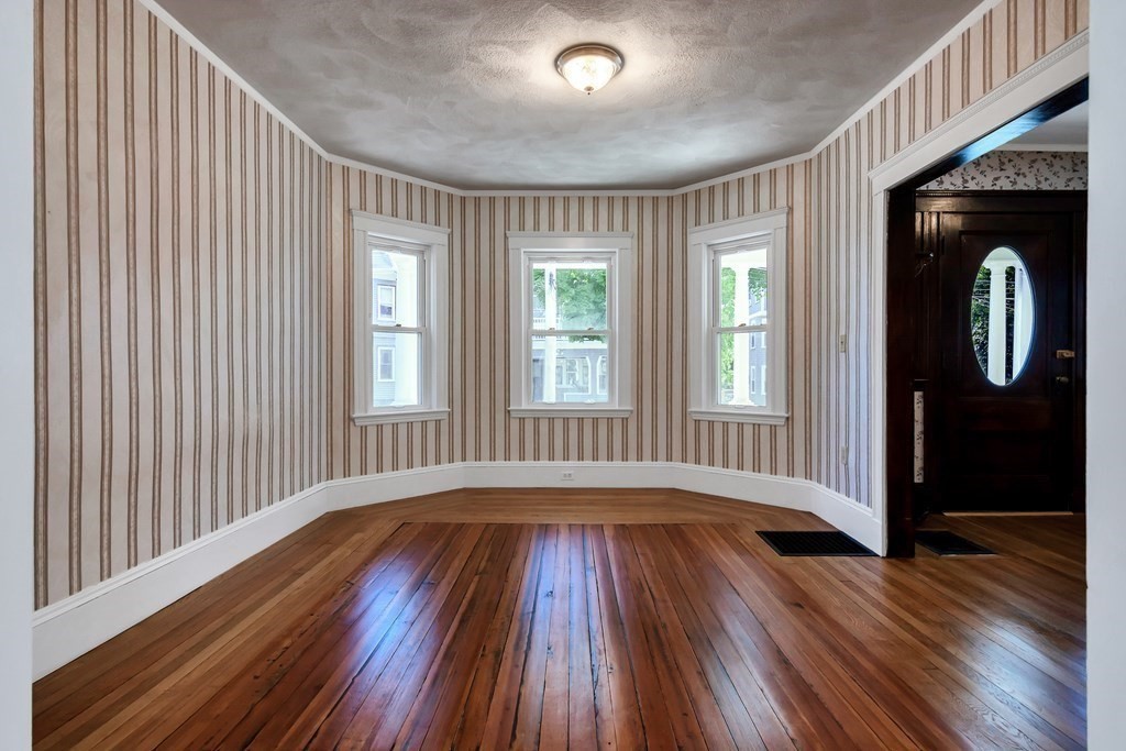 20 Usher Road Medford, MA 02155 - Photo 7 of 42 a view of an empty room with wooden floor and a window