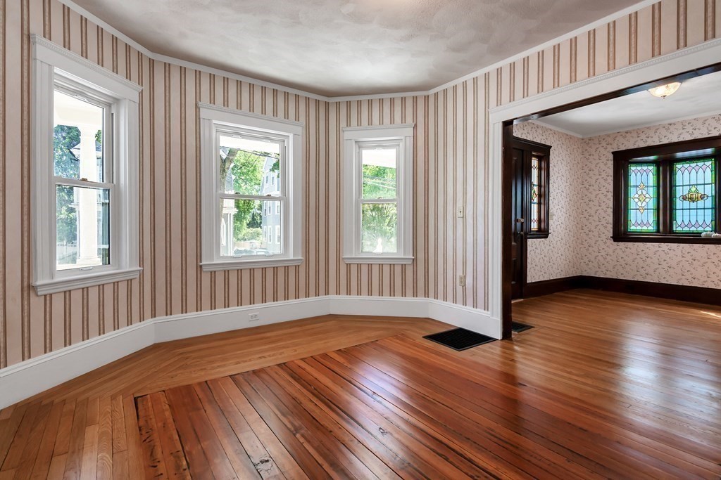 20 Usher Road Medford, MA 02155 - Photo 8 of 42 a view of an empty room with wooden floor and a window