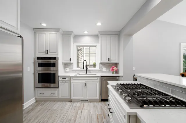 a kitchen with a sink stove and refrigerator