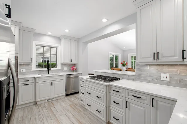 a kitchen with a stove a sink and a refrigerator