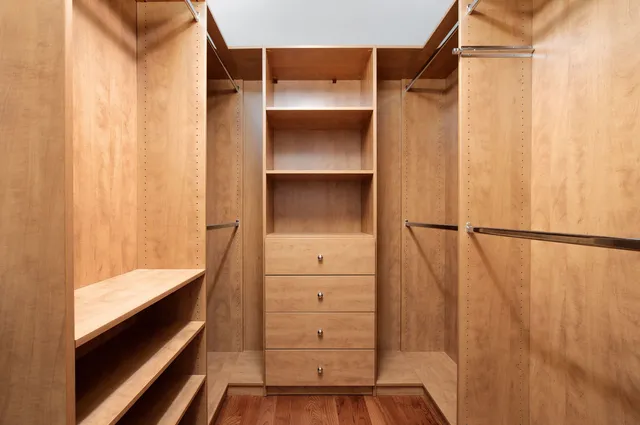 a view of walk in closet with empty racks