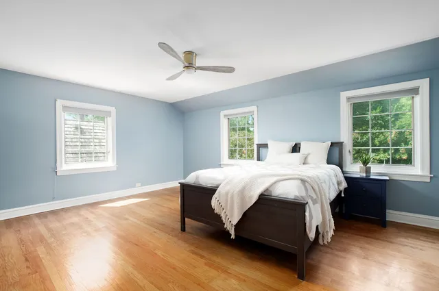 a large bed sitting in a bedroom next to a window