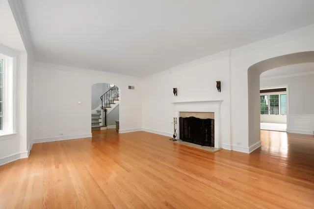 wooden floor fireplace and natural light in room