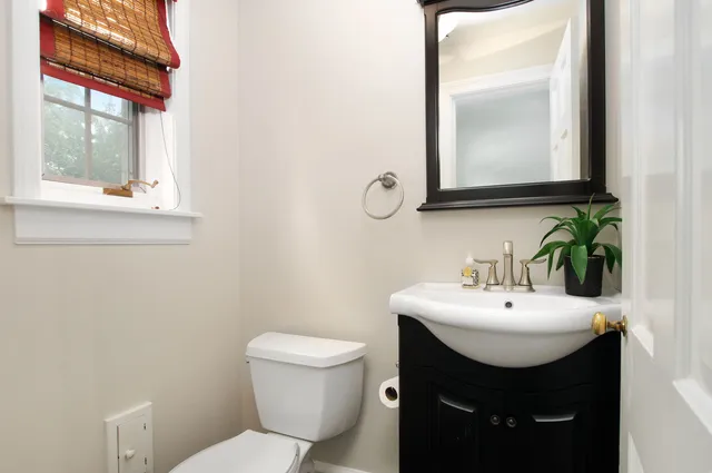 a bathroom with a sink toilet and mirror