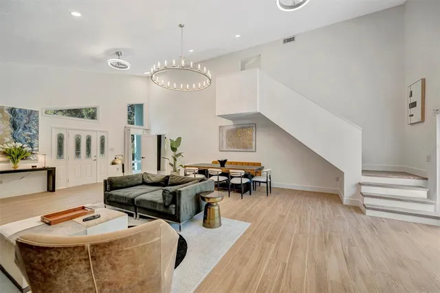a large white kitchen with cabinets