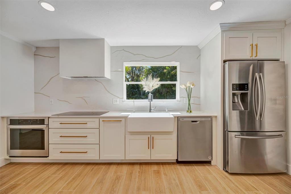 403 Longbow Trail Osprey, FL 34229 - Photo 23 of 99 a kitchen with stainless steel appliances a refrigerator and a sink
