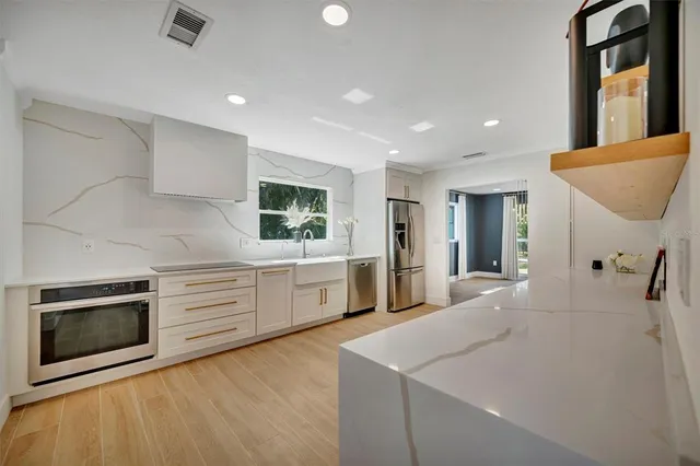 a kitchen with white cabinets and white appliances