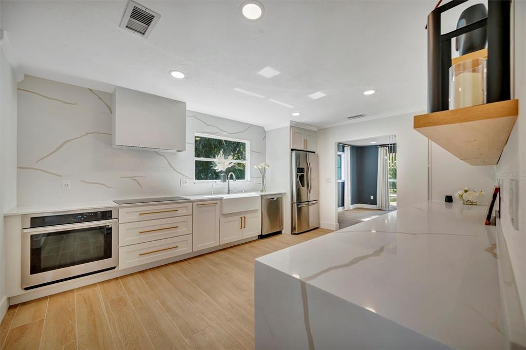 403 Longbow Trail Osprey, FL 34229 - Photo 28 of 99 a large white kitchen with sink and stainless steel appliances