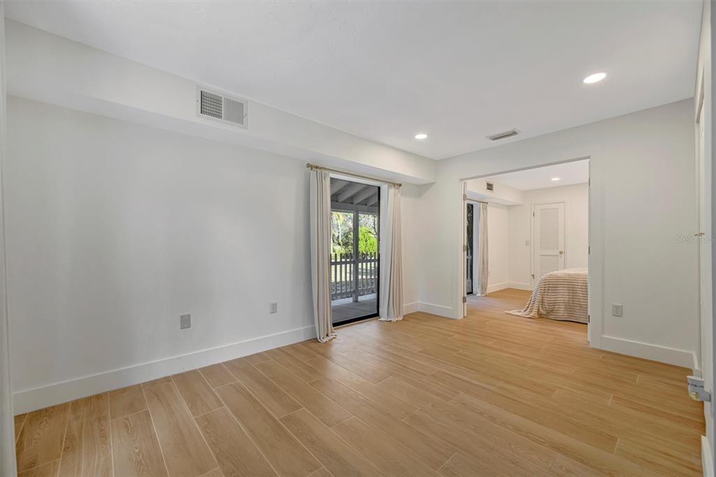 403 Longbow Trail Osprey, FL 34229 - Photo 35 of 99 a view of an empty room with wooden floor and a window