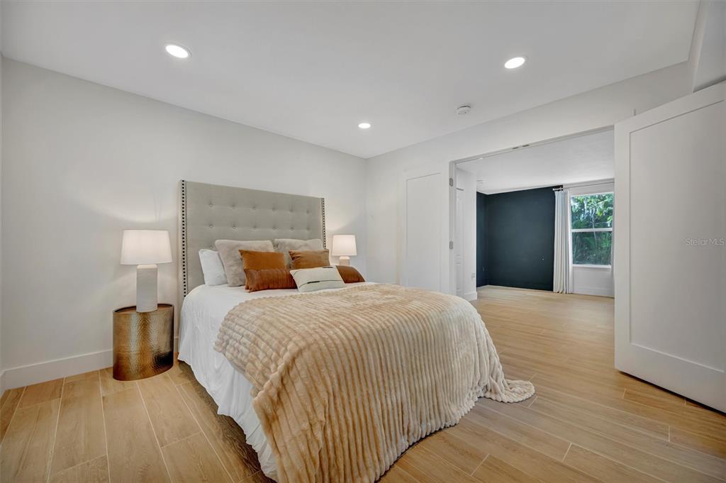 403 Longbow Trail Osprey, FL 34229 - Photo 39 of 99 a bedroom with a bed and a night stand