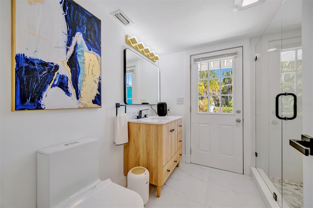 403 Longbow Trail Osprey, FL 34229 - Photo 44 of 99 a bathroom with a sink mirror vanity and toilet