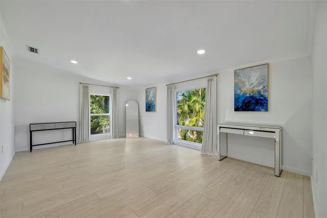 a view of a yard with plants and trees