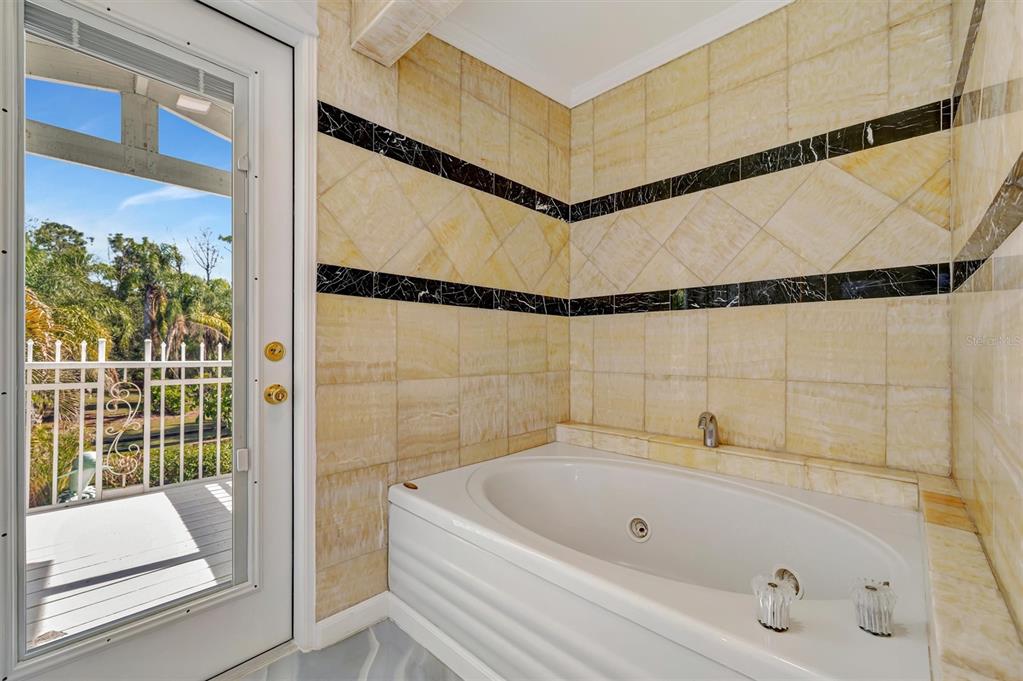 403 Longbow Trail Osprey, FL 34229 - Photo 52 of 99 a bathroom with a tub and shower