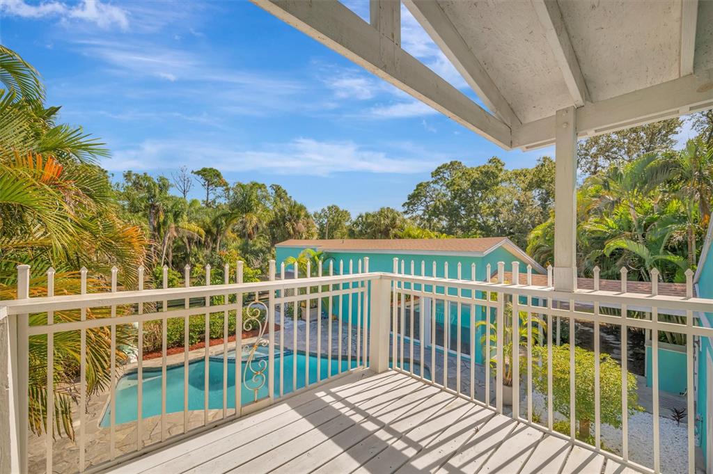 403 Longbow Trail Osprey, FL 34229 - Photo 55 of 99 a view of a balcony with wooden floor & fence