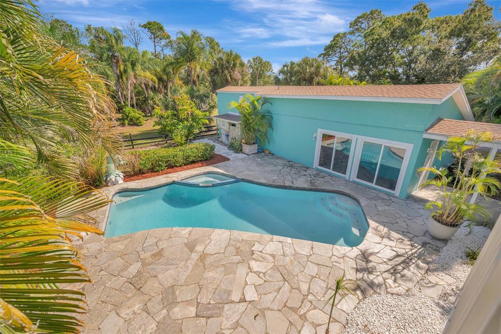 403 Longbow Trail Osprey, FL 34229 - Photo 57 of 99 a view of a backyard with plants and a patio