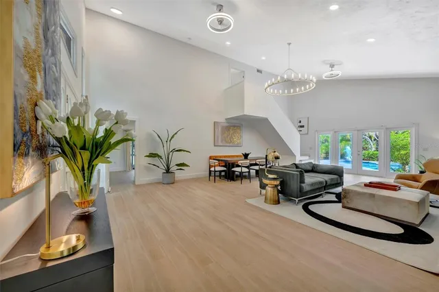 a living room with furniture a flat screen tv and a large window